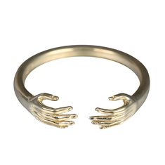 an open gold ring with two hands on the front and back of it, against a white background