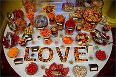 a table topped with lots of different types of candy and candies on top of it