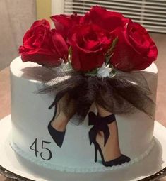 a white cake with red roses on top