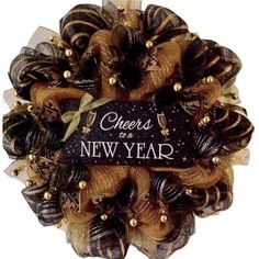 a black and gold wreath with cheers to a new year written on it's side