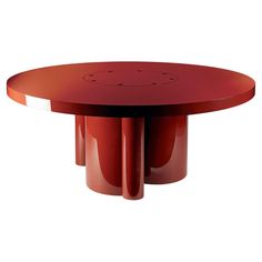 a red table with four legs and a circular top