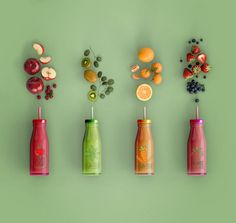 various fruit and vegetable juices arranged on a green background