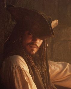 a man with dreadlocks and a pirate hat