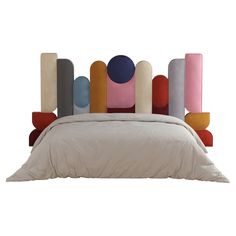 an upholstered headboard made out of different colored pillows on a white bed