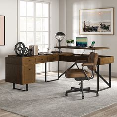 an office with a desk, chair and computer on the table in front of a window