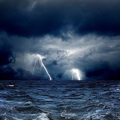 two lightning strikes over the ocean on a stormy day