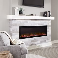 a living room with a couch, chair and fire place in the fireplace that is built into the wall