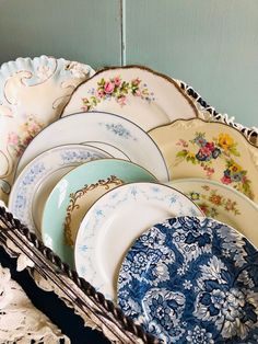 a basket filled with lots of plates on top of a table