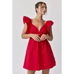 The Audrey tie-back is a mini dress with a bow in back and ruffled sleeves. Flouncy mini skirt at the bottom is accentuated by a gorgeous red shade. Fabric: 100% Cotton. Size guide: Small - 2/4 Medium - 4/6 Large - 6/10 Length :27 5/8 Chest: 15 1/4 Ruffle width: 4 1/2 Model's height is 5' 8" and wearing a size S Red Mini Dress With Ruffle Hem, Red Mini Dress With Tie Back, Red Mini Dress With Ruffle Hem For Night Out, Red Ruffled Mini Dress, Chic Solid Mini Dress With Ruffle Sleeves, Red Mini Ruffle Dress, Red Summer Dress With Bow Tie Back, Flirty Red Mini Dress With Ruffles, Red A-line Mini Dress For Brunch