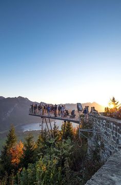 a group of people standing on top of a bridge