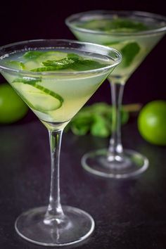 two martini glasses filled with limeade and cucumber