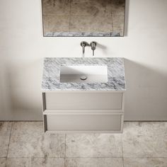 a bathroom sink sitting under a mirror next to a wall mounted faucet on a tiled floor