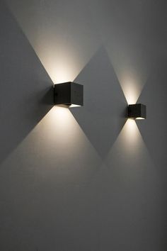 two square lights are on the wall next to each other