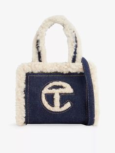 Ugg X Telfar denim shopper100% cotton; trims 100% sheep leatherMagnetic fasteningCross-body straps, brand woven logo at front, interior zip-fastened patch pocket, sheepskin trimHeight 40cm, width 12cm, depth 8cmWipe with a clean, dry cloth Telfar Small Bag, Dream Wishlist, My Style Bags, Handbag Essentials, Girly Bags, Denim Tote Bags, Denim Tote, Pretty Bags, Cute Bags