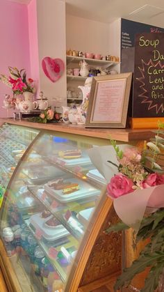 a display case in a bakery filled with lots of cakes and cupcakes for sale