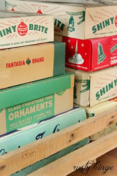 several boxes stacked on top of each other in a wooden box shelf with christmas ornaments