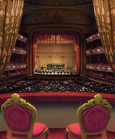 two chairs facing each other in front of an auditorium