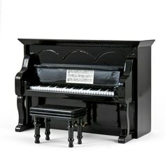 a black piano and stool are shown in front of a white background with the words, music