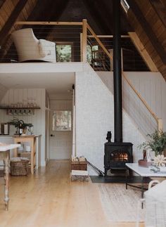 a living room filled with furniture and a fire place in the middle of a house