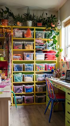 a room filled with lots of different colored bins and shelves next to a window