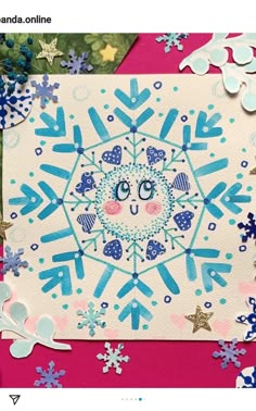 a card with an image of a snowflake on it and some paper decorations around it