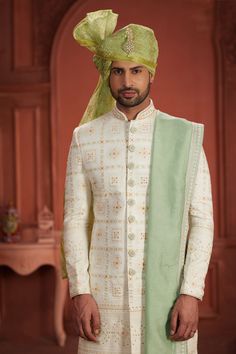 Elevate your wedding look with our exquisite readymade sherwani, meticulously crafted from luxurious silk fabric. This masterpiece boasts intricate embroidery work, adding a touch of regal elegance and timeless charm. Designed to make you stand out, our sherwani is the epitome of sophistication and style, perfect for the most significant day of your life. Regal Elegance, Wedding Look, Intricate Embroidery, Off White Color, White Silk, Embroidery Work, Wedding Looks, White Fabrics, Silk Fabric