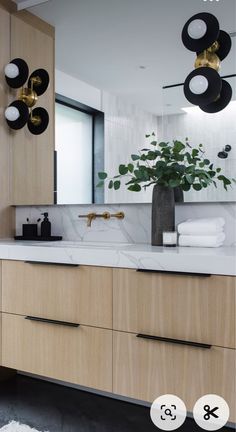 a bathroom with wooden cabinets and marble counter tops