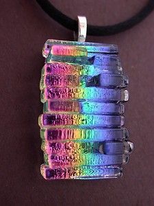 a multicolored glass pendant on a black cord