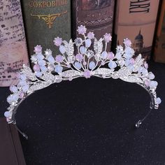 a tiara is sitting on a table next to books