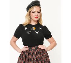 This bewitching Unique Vintage Halloween embroidered short sleeve sweater is perfect for adding a touch of spooky charm to your seasonal wardrobe. Crafted in a soft black sweater knit, it features a sweet pintuck diamond design and an embroidered Halloween motif in the center. From Unique Vintage. Gothic Short Sleeve Tops For Fall, Embroidered Halloween, Seasonal Wardrobe, Short Sleeve Sweater, Embroidered Shorts, Black Sweater, Pin Tucks, Diamond Design, Short Sleeved Sweaters