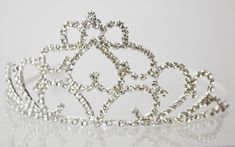 LOVELY QUINCEANERA TIARA YOU ARE GETTING 1  AS SHOWN PERFECT FOR FIRST COMMUNION, QUINCEANERA, BIRTHDAY, ETC MEASURES 3.5" TALL and 5.25" wide (expands a little more to fit head if necessary) QUALITY TIARA  CRAFTED  WITH RHINESTONES AND METAL Quinceanera Tiaras, Tiara Headband, Heart Rhinestone, Tiara Crown, Headband Tiara, Silver Crown, Crown Headband, Tiaras And Crowns, Princess Birthday