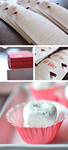 red and white desserts are on display in pink paper wrappers, along with menus