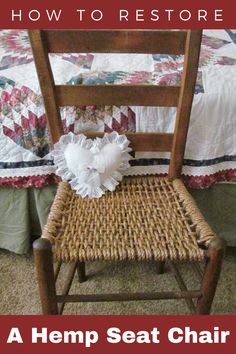 a wooden chair sitting in front of a bed with a quilt on top of it