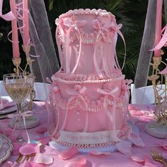 a large pink cake sitting on top of a table