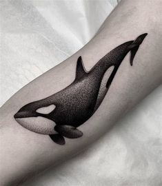 an orca whale tattoo on the arm