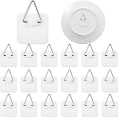 white paper clips and magnets are arranged in the shape of trianglees on a white background