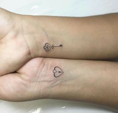 two people with matching tattoos on their arms, one has a heart and the other has an arrow