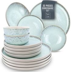 the dinnerware set is light blue and has white speckles on it's rim