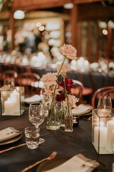 the table is set with candles and flowers