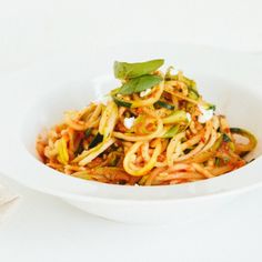 a white bowl filled with pasta and vegetables