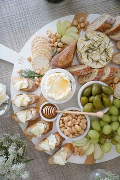 a platter filled with cheese, crackers and olives