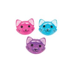 three different colored cat shaped buttons on a white background