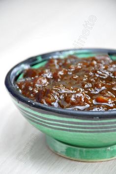 a green bowl filled with food on top of a table