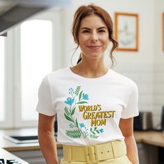 a woman wearing a world's greatest mom t - shirt in an office setting