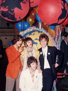 the rolling stones pose for a photo in front of balloons