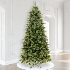 a small christmas tree in a white room