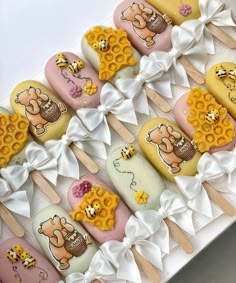 a box filled with lots of different types of cakes on top of wooden skewers