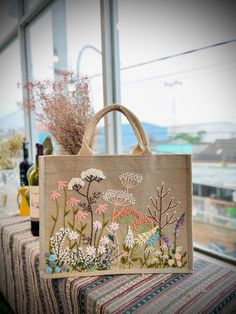 an embroidered bag sitting on top of a table