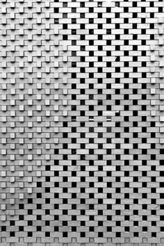 a black and white photo of a wall with squares on it