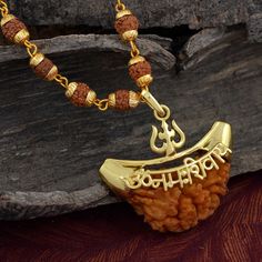 The One mukhi Rudraksha is blessed by Lord Shiva and its controlling planet is the Sun. It is beneficial for those desiring excellence in meditation, yoga and growth. It is excellent for spiritual growth, meditation and developing better focus. This Rudraksha negates the malefic effects of Sun. Rudhraksh Chain Length-66 CM X Width -6 MM, Pendant Width -3.5 CM,Pendant Length-3.8 CM Material : Brass Care instructions: Keep this product away from sprays, water and other corrosive liquids 1 Mukhi Rudraksha Pendent, Gold Spiritual Temple Necklace For Navratri, Gold Mala As Navratri Gift, Gold Mala For Navratri Gift, Spiritual Gold Temple Necklace For Festivals, Spiritual Temple Necklace For Festival Gifts, Festive Temple Jewelry For Meditation, Diwali Rituals Mala With Pallu, Festive Spiritual Temple Necklace With Latkans